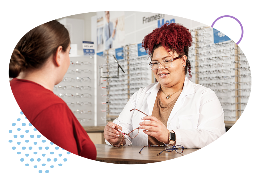Optometrist handing a pair of glasses to a patient